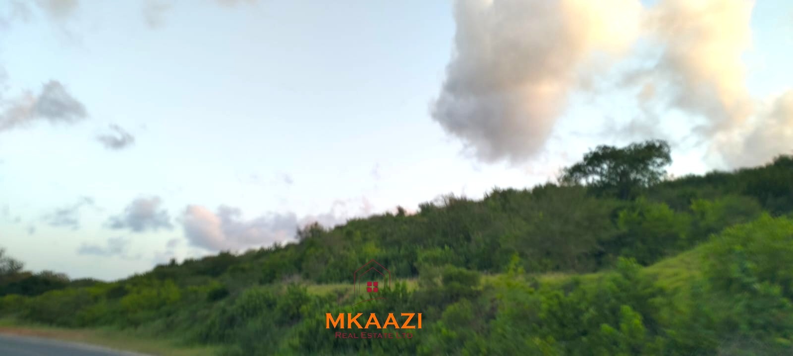 37 acres freehold cliffside road frontage land for sale at Marafa Bridge overlooking seasonal river and Marafa town ideal for agriculture, hospitality, and investment development.