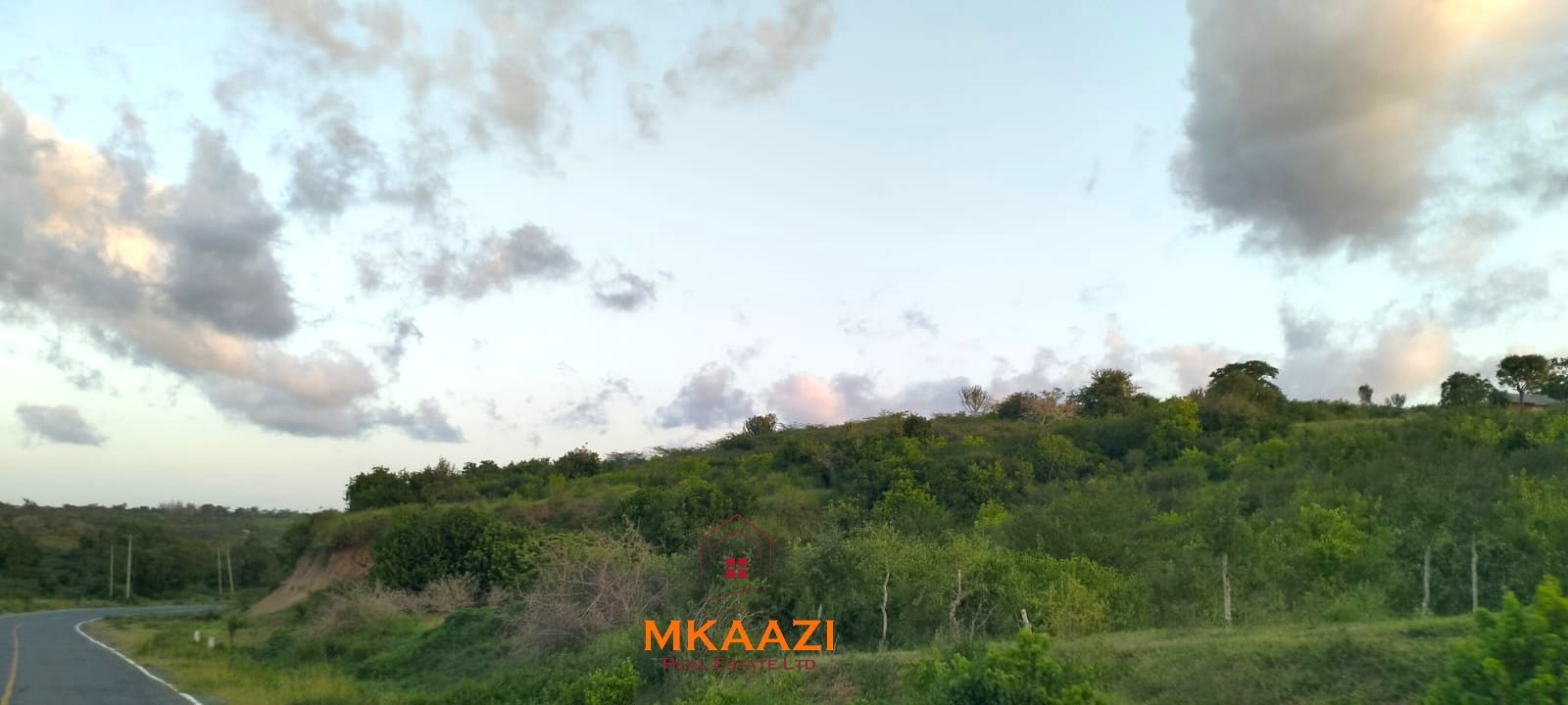 37 acres freehold cliffside road frontage land for sale at Marafa Bridge overlooking seasonal river and Marafa town ideal for agriculture, hospitality, and investment development.