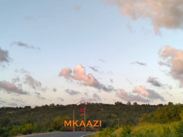 37 acres freehold cliffside road frontage land for sale at Marafa Bridge overlooking seasonal river and Marafa town ideal for agriculture, hospitality, and investment development.