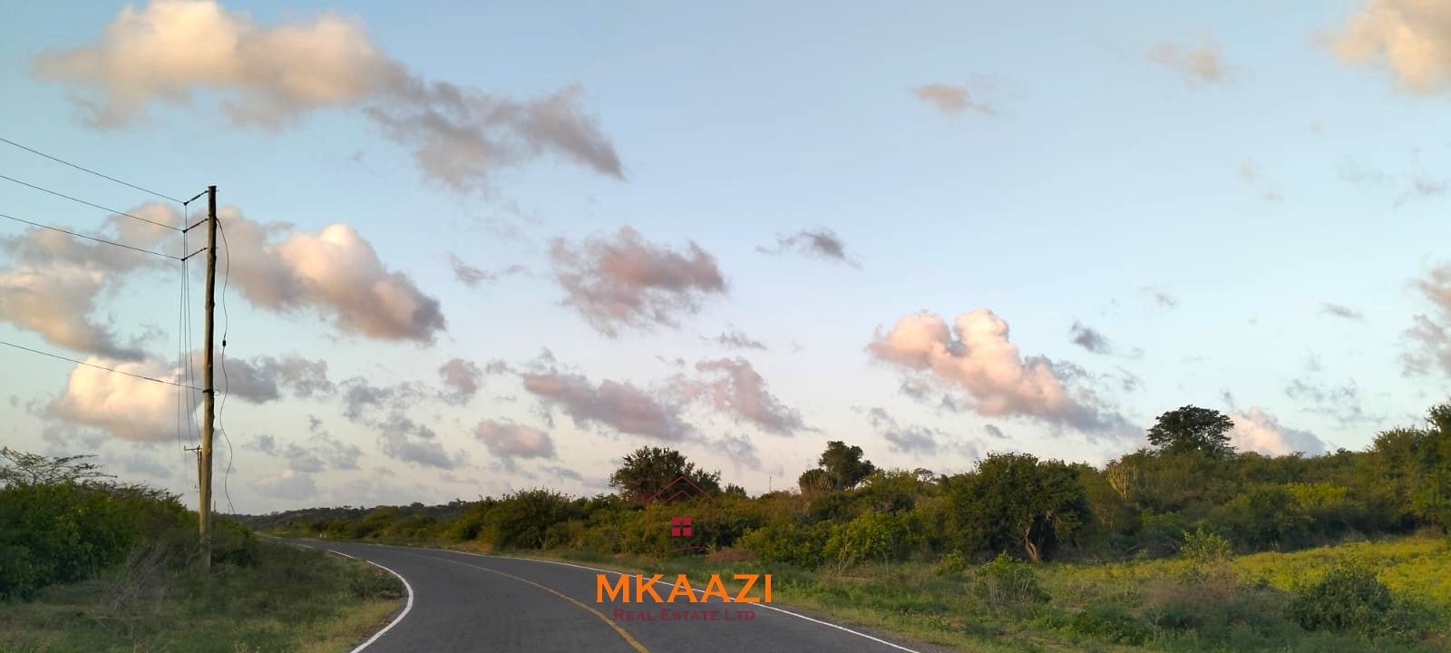 37 acres freehold cliffside road frontage land for sale at Marafa Bridge overlooking seasonal river and Marafa town ideal for agriculture, hospitality, and investment development.