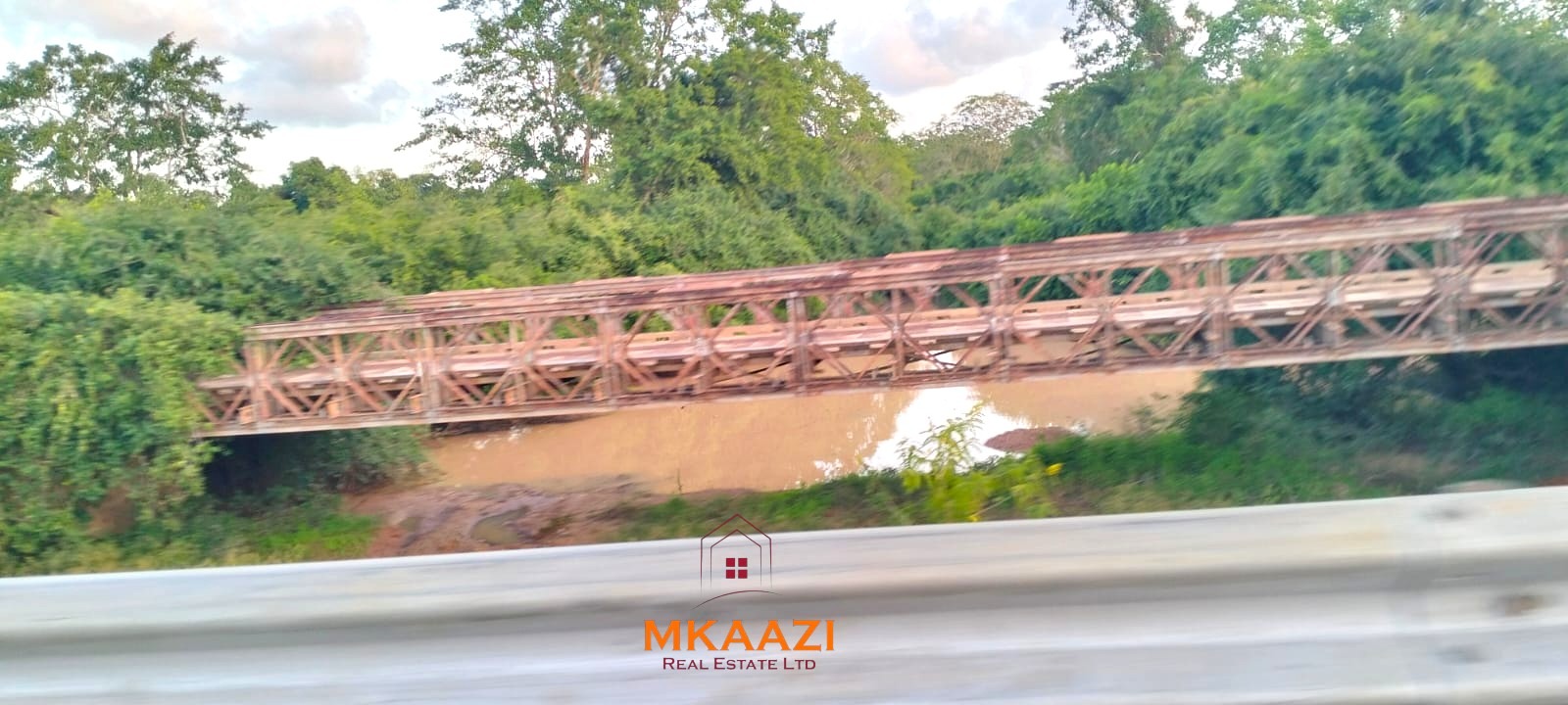 37 acres freehold cliffside road frontage land for sale at Marafa Bridge overlooking seasonal river and Marafa town ideal for agriculture, hospitality, and investment development.