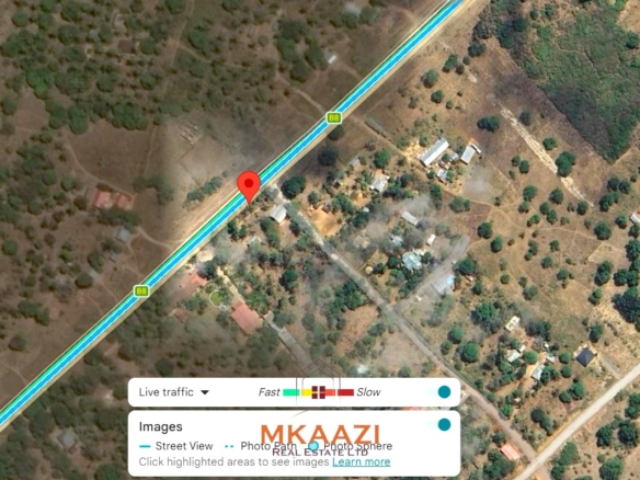2-acre highway frontage property for sale in Matsangoni with house, shops, mature trees, and commercial investment potential.