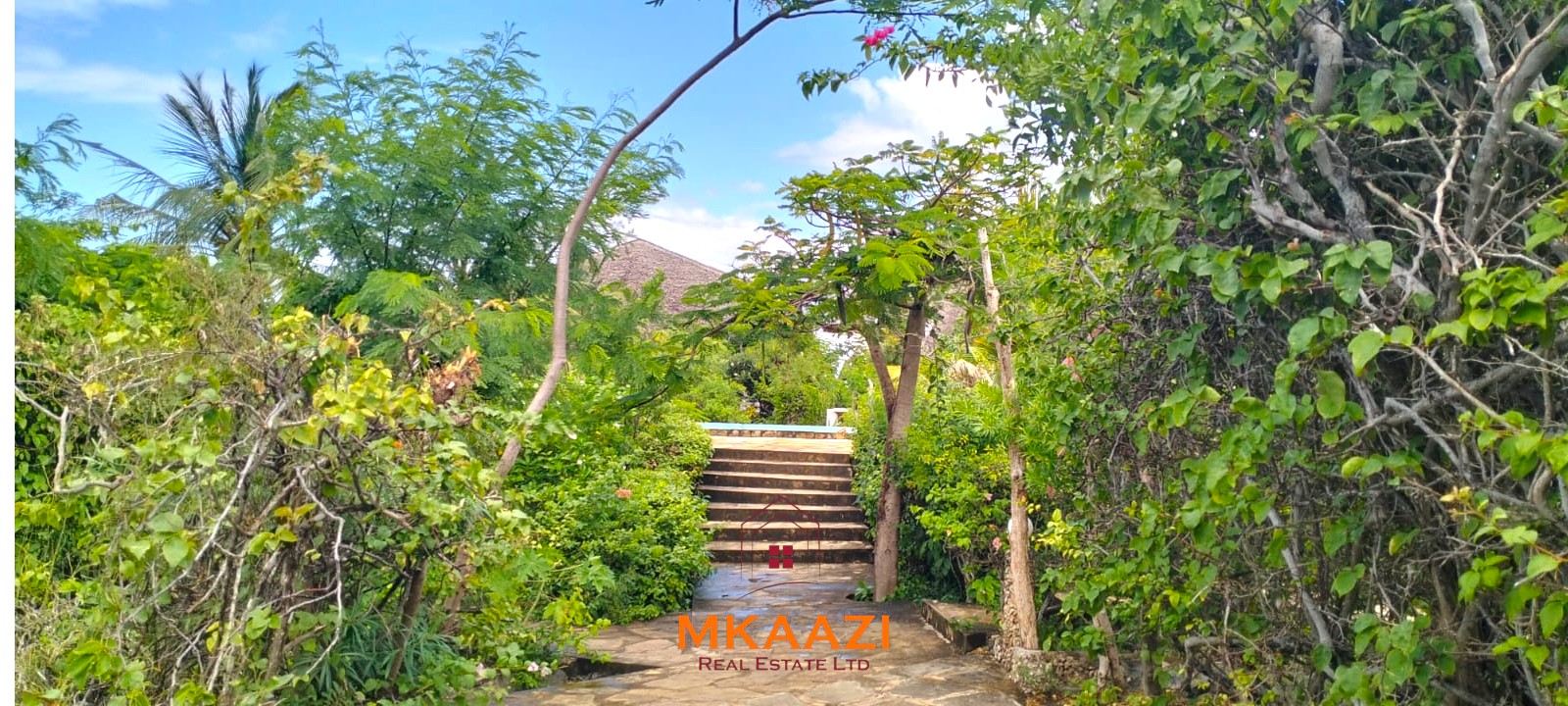 Luxury 4-bedroom house for sale in Mayungu, located in a secure gated community on the second row from the beach, featuring a shared swimming pool, landscaped garden, and serene coastal surroundings.