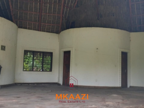 Luxury 4-bedroom house for sale in Mayungu, located in a secure gated community on the second row from the beach, featuring a shared swimming pool, landscaped garden, and serene coastal surroundings.