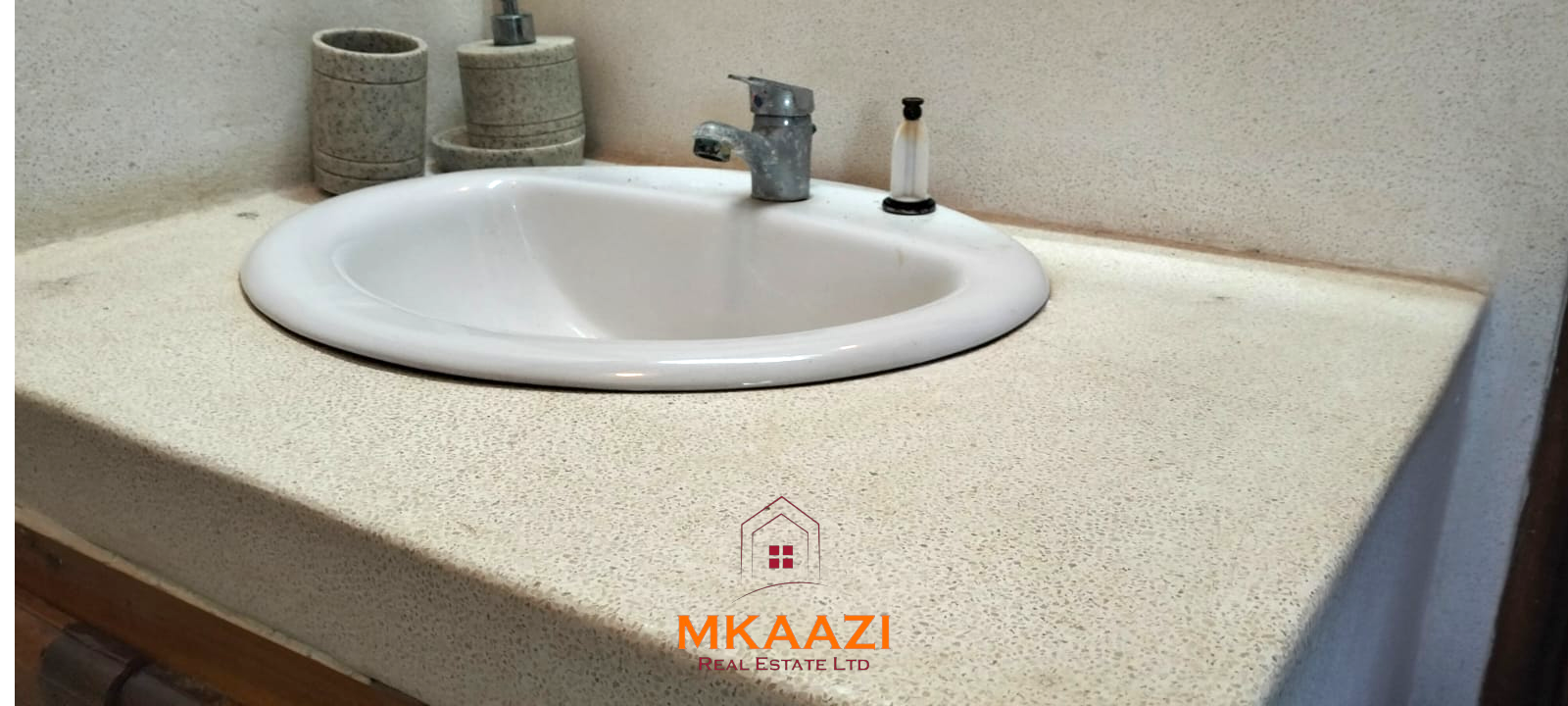Luxury 4-bedroom house for sale in Mayungu, located in a secure gated community on the second row from the beach, featuring a shared swimming pool, landscaped garden, and serene coastal surroundings.