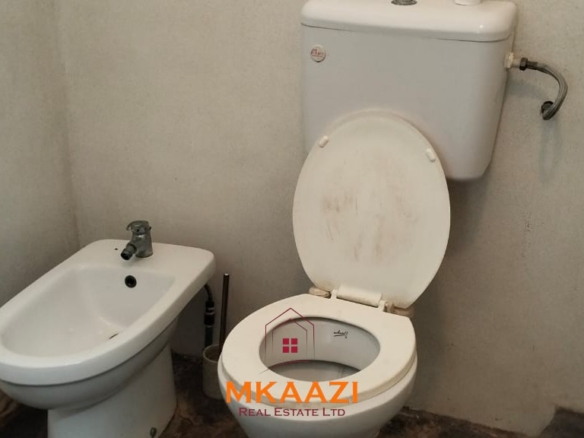 Luxury 4-bedroom house for sale in Mayungu, located in a secure gated community on the second row from the beach, featuring a shared swimming pool, landscaped garden, and serene coastal surroundings.