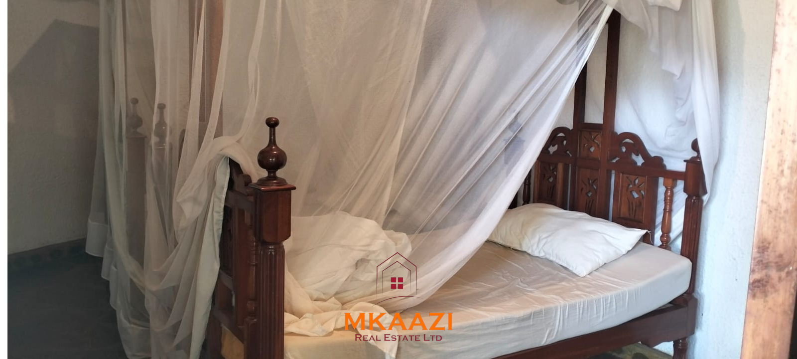 Luxury 4-bedroom house for sale in Mayungu, located in a secure gated community on the second row from the beach, featuring a shared swimming pool, landscaped garden, and serene coastal surroundings.