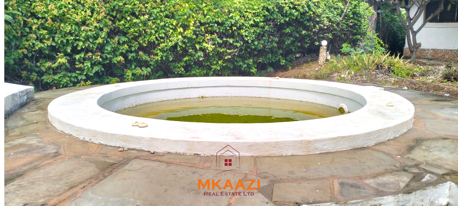 Luxury 4-bedroom house for sale in Mayungu, located in a secure gated community on the second row from the beach, featuring a shared swimming pool, landscaped garden, and serene coastal surroundings.