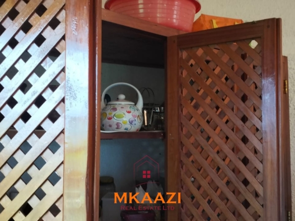Luxury 4-bedroom house for sale in Mayungu, located in a secure gated community on the second row from the beach, featuring a shared swimming pool, landscaped garden, and serene coastal surroundings.
