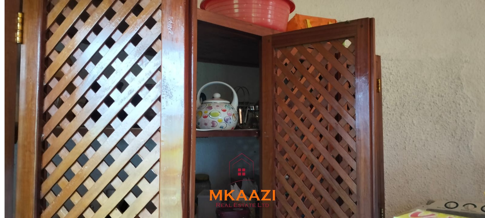 Luxury 4-bedroom house for sale in Mayungu, located in a secure gated community on the second row from the beach, featuring a shared swimming pool, landscaped garden, and serene coastal surroundings.