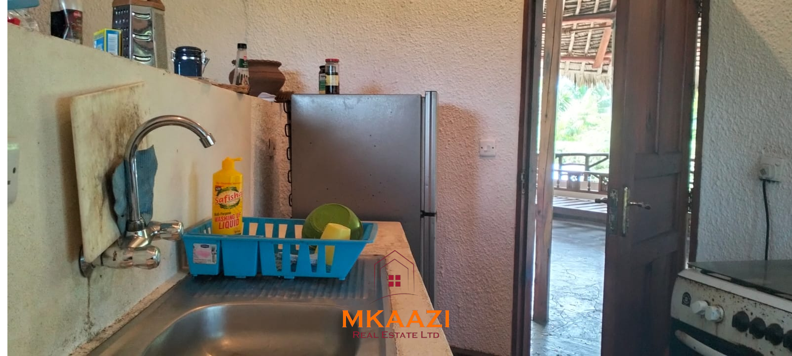 Luxury 4-bedroom house for sale in Mayungu, located in a secure gated community on the second row from the beach, featuring a shared swimming pool, landscaped garden, and serene coastal surroundings.