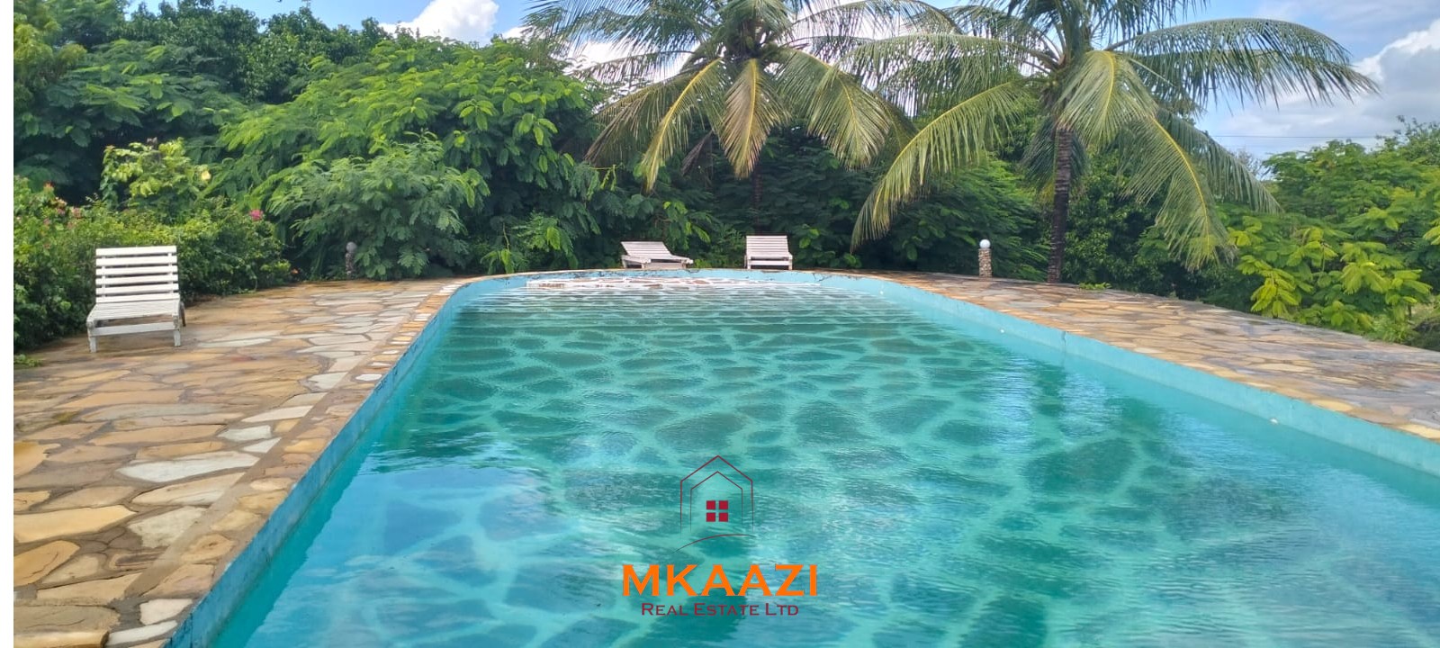 Luxury 4-bedroom house for sale in Mayungu, located in a secure gated community on the second row from the beach, featuring a shared swimming pool, landscaped garden, and serene coastal surroundings.