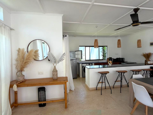 Luxury fully furnished twin villas for sale on Turtle Bay Road Watamu near Temple Point and LichtHaus featuring 4 bedrooms total, proven hospitality income, 70% occupancy rates, private terraces, DSQ, and strong ROI potential.