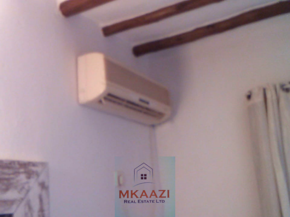Fully furnished 2-bedroom luxury apartment for sale in Silver Rock Malindi along Casuarina Road featuring beach access, swimming pool, private garden, spacious rooms, porch, bathtub, and 24/7 security.