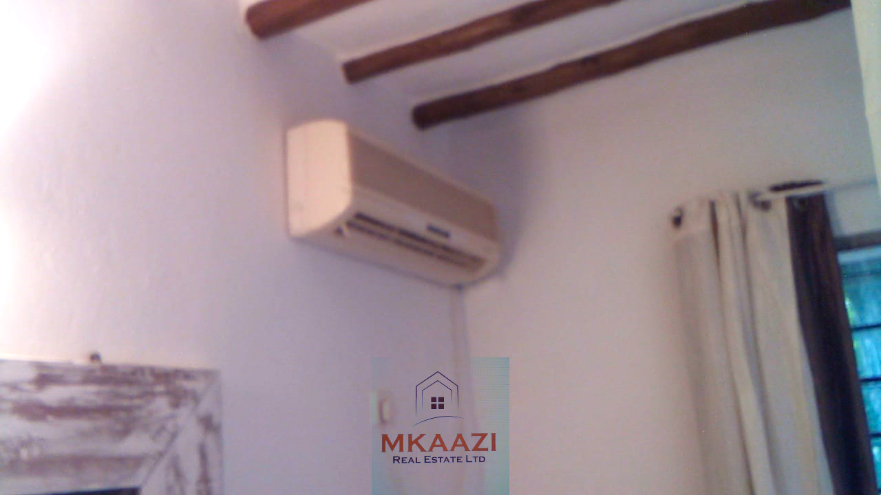 Fully furnished 2-bedroom luxury apartment for sale in Silver Rock Malindi along Casuarina Road featuring beach access, swimming pool, private garden, spacious rooms, porch, bathtub, and 24/7 security.