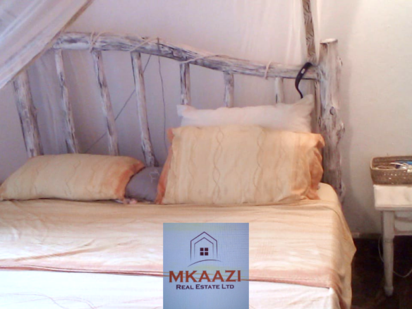 Fully furnished 2-bedroom luxury apartment for sale in Silver Rock Malindi along Casuarina Road featuring beach access, swimming pool, private garden, spacious rooms, porch, bathtub, and 24/7 security.