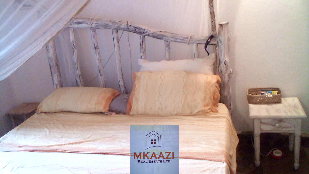 Fully furnished 2-bedroom luxury apartment for sale in Silver Rock Malindi along Casuarina Road featuring beach access, swimming pool, private garden, spacious rooms, porch, bathtub, and 24/7 security.