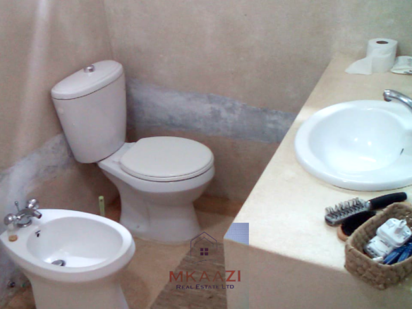 Fully furnished 2-bedroom luxury apartment for sale in Silver Rock Malindi along Casuarina Road featuring beach access, swimming pool, private garden, spacious rooms, porch, bathtub, and 24/7 security.