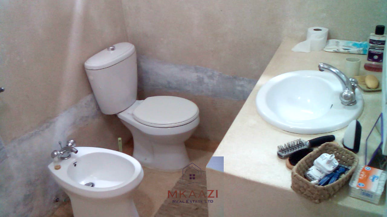 Fully furnished 2-bedroom luxury apartment for sale in Silver Rock Malindi along Casuarina Road featuring beach access, swimming pool, private garden, spacious rooms, porch, bathtub, and 24/7 security.