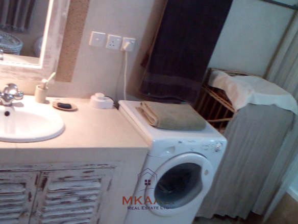 Fully furnished 2-bedroom luxury apartment for sale in Silver Rock Malindi along Casuarina Road featuring beach access, swimming pool, private garden, spacious rooms, porch, bathtub, and 24/7 security.