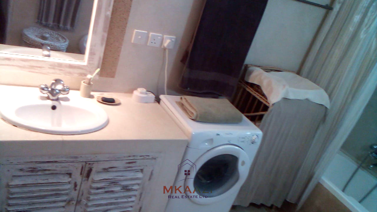 Fully furnished 2-bedroom luxury apartment for sale in Silver Rock Malindi along Casuarina Road featuring beach access, swimming pool, private garden, spacious rooms, porch, bathtub, and 24/7 security.