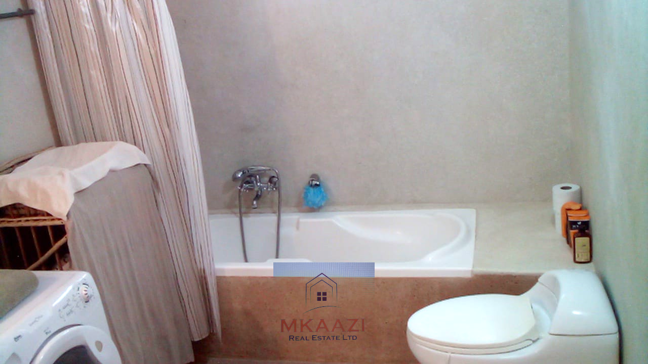 Fully furnished 2-bedroom luxury apartment for sale in Silver Rock Malindi along Casuarina Road featuring beach access, swimming pool, private garden, spacious rooms, porch, bathtub, and 24/7 security.
