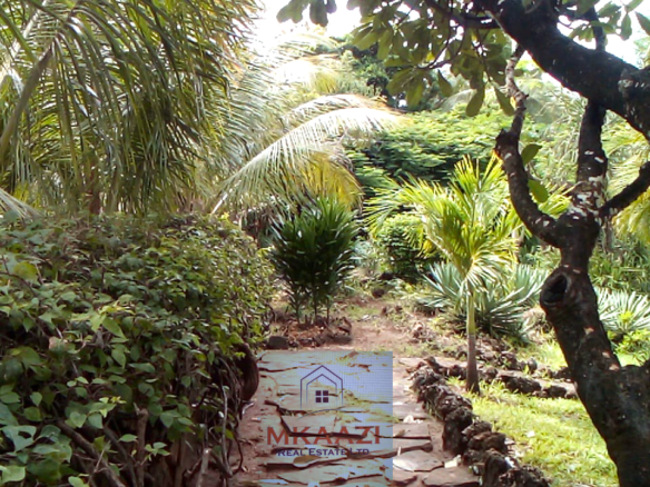Fully furnished 2-bedroom luxury apartment for sale in Silver Rock Malindi along Casuarina Road featuring beach access, swimming pool, private garden, spacious rooms, porch, bathtub, and 24/7 security.