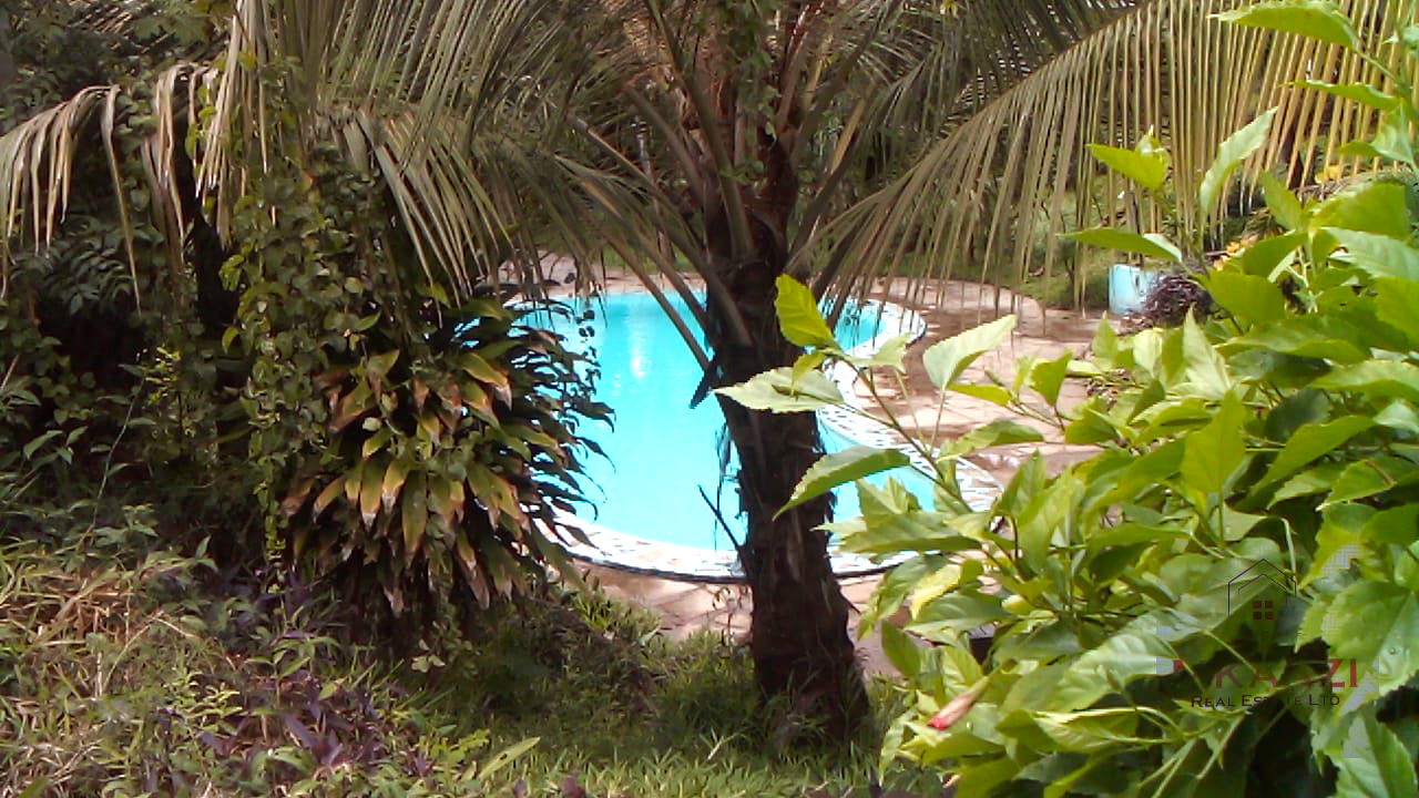 Fully furnished 2-bedroom luxury apartment for sale in Silver Rock Malindi along Casuarina Road featuring beach access, swimming pool, private garden, spacious rooms, porch, bathtub, and 24/7 security.