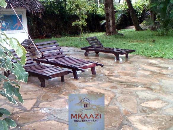 Fully furnished 2-bedroom luxury apartment for sale in Silver Rock Malindi along Casuarina Road featuring beach access, swimming pool, private garden, spacious rooms, porch, bathtub, and 24/7 security.