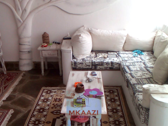 Fully furnished 2-bedroom luxury apartment for sale in Silver Rock Malindi along Casuarina Road featuring beach access, swimming pool, private garden, spacious rooms, porch, bathtub, and 24/7 security.