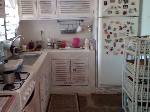 Fully furnished 2-bedroom luxury apartment for sale in Silver Rock Malindi along Casuarina Road featuring beach access, swimming pool, private garden, spacious rooms, porch, bathtub, and 24/7 security.