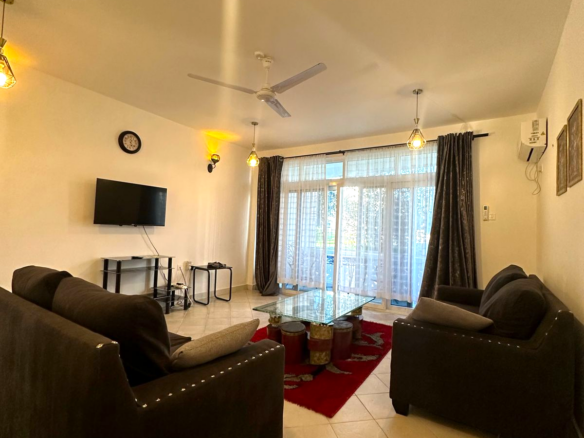 Fully furnished 2-bedroom apartment for sale in Kijani Malindi featuring spacious bedrooms, balcony views, swimming pool access, and walking distance to the beach.