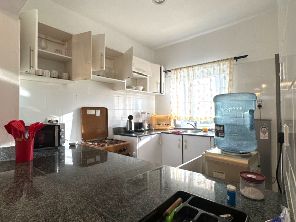 Fully furnished 2-bedroom apartment for sale in Kijani Malindi featuring spacious bedrooms, balcony views, swimming pool access, and walking distance to the beach.