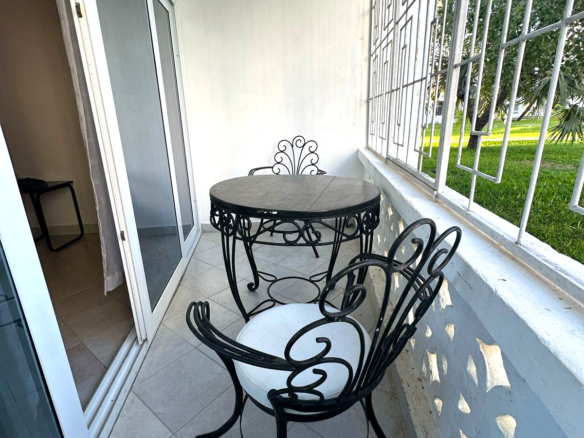 Fully furnished 2-bedroom apartment for sale in Kijani Malindi featuring spacious bedrooms, balcony views, swimming pool access, and walking distance to the beach.