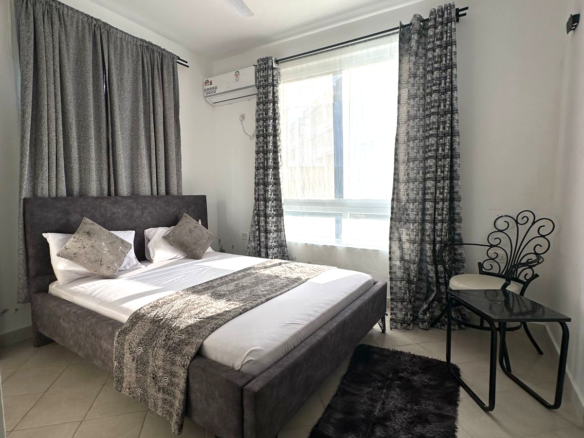 Fully furnished 2-bedroom apartment for sale in Kijani Malindi featuring spacious bedrooms, balcony views, swimming pool access, and walking distance to the beach.