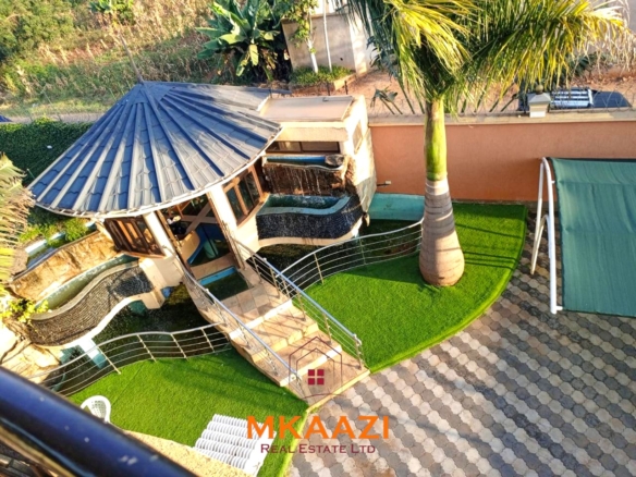 Luxury 6-bedroom all-ensuite mansion for sale in Githingiri Estate, Thika, featuring a gym, safe room, CCTV surveillance, automated gate, electrified perimeter wall, and 35,000-litre underground water tank.