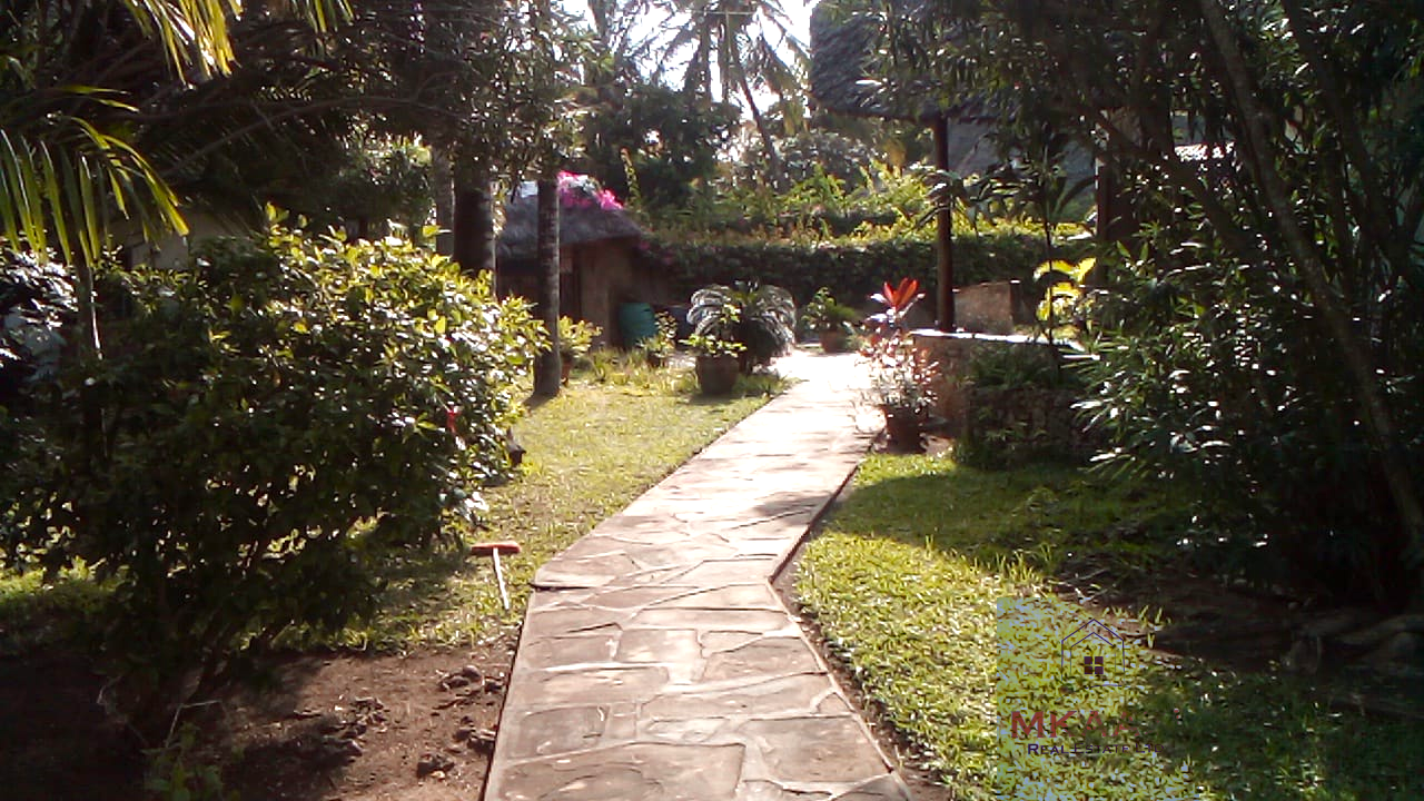 Luxury 3-bedroom villa with staff quarter for sale in Aquarius Watamu on a quarter-acre plot, featuring a gazebo, spacious porch, and walking distance access to the beach.