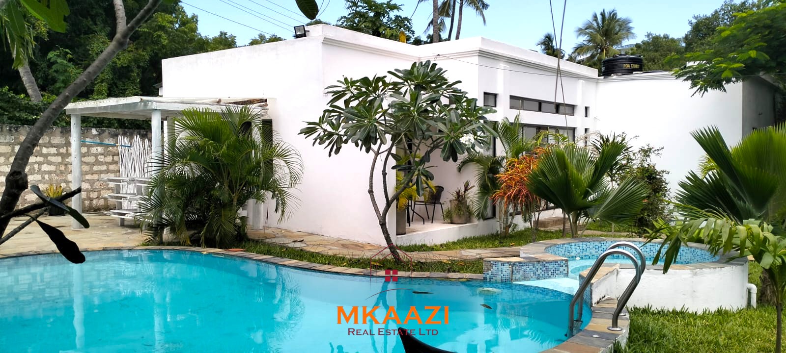 Two 2-bedroom bungalows for sale near Garoda on a quarter-acre property featuring ensuite master bedrooms with bathtubs, swimming pool, landscaped gardens, and operating as a hospitality business.