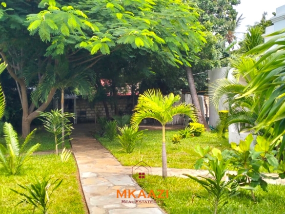 Two 2-bedroom bungalows for sale near Garoda on a quarter-acre property featuring ensuite master bedrooms with bathtubs, swimming pool, landscaped gardens, and operating as a hospitality business.