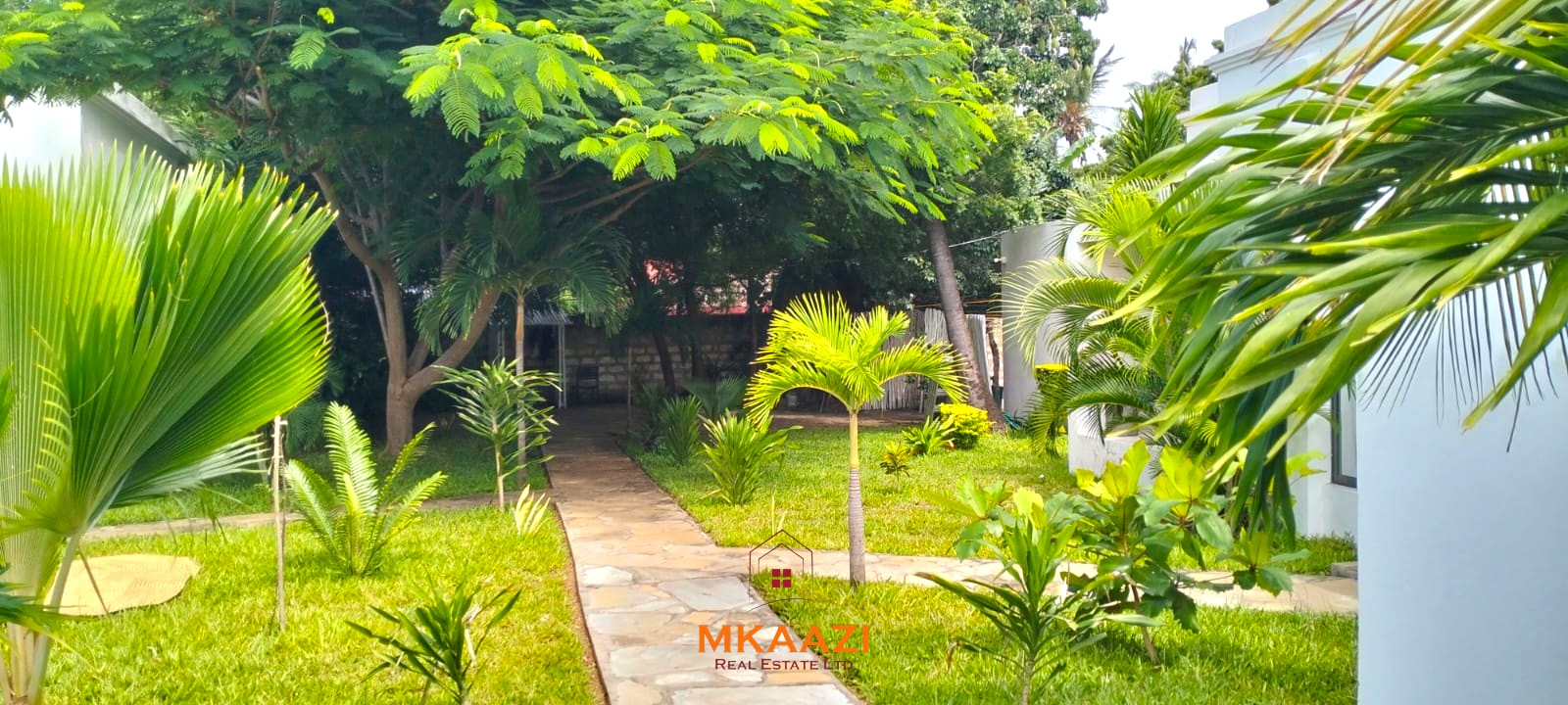 Two 2-bedroom bungalows for sale near Garoda on a quarter-acre property featuring ensuite master bedrooms with bathtubs, swimming pool, landscaped gardens, and operating as a hospitality business.