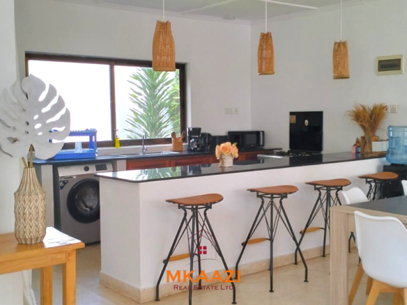 Two 2-bedroom bungalows for sale near Garoda on a quarter-acre property featuring ensuite master bedrooms with bathtubs, swimming pool, landscaped gardens, and operating as a hospitality business.