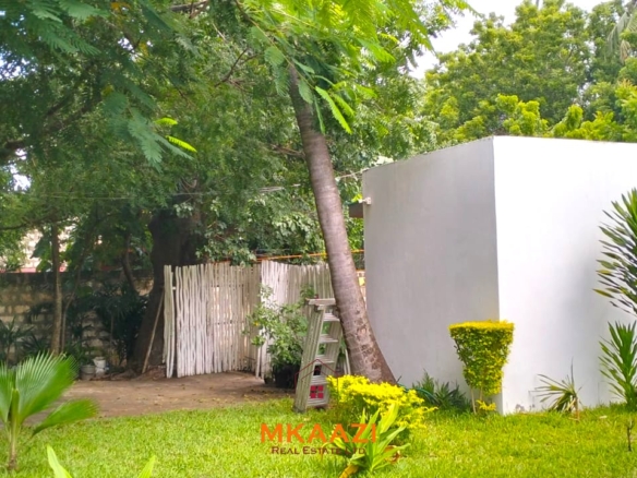Two 2-bedroom bungalows for sale near Garoda on a quarter-acre property featuring ensuite master bedrooms with bathtubs, swimming pool, landscaped gardens, and operating as a hospitality business.