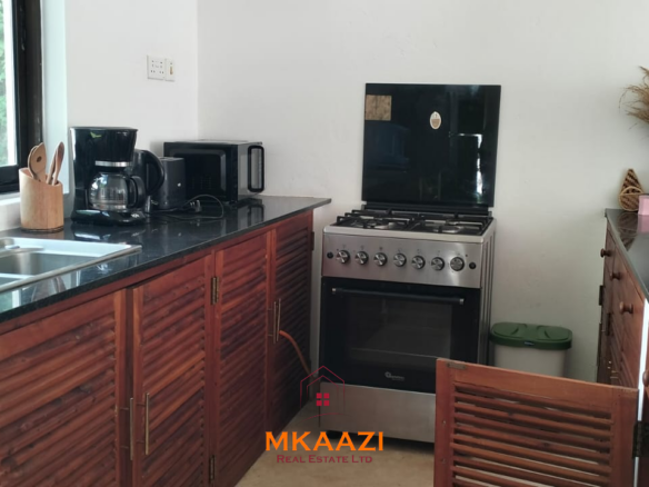 Two 2-bedroom bungalows for sale near Garoda on a quarter-acre property featuring ensuite master bedrooms with bathtubs, swimming pool, landscaped gardens, and operating as a hospitality business.