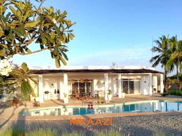Luxury 3-bedroom all en-suite villa on 1.5 acres in Kikambala featuring a guest house, swimming pool, landscaped gardens, ocean breeze, and easy beach access.