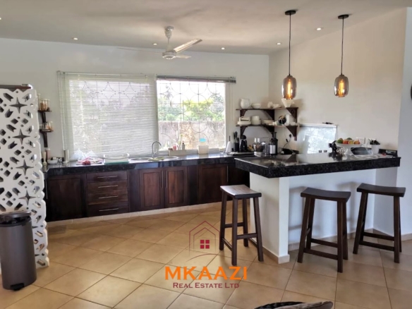 Luxury 3-bedroom all en-suite villa on 1.5 acres in Kikambala featuring a guest house, swimming pool, landscaped gardens, ocean breeze, and easy beach access.