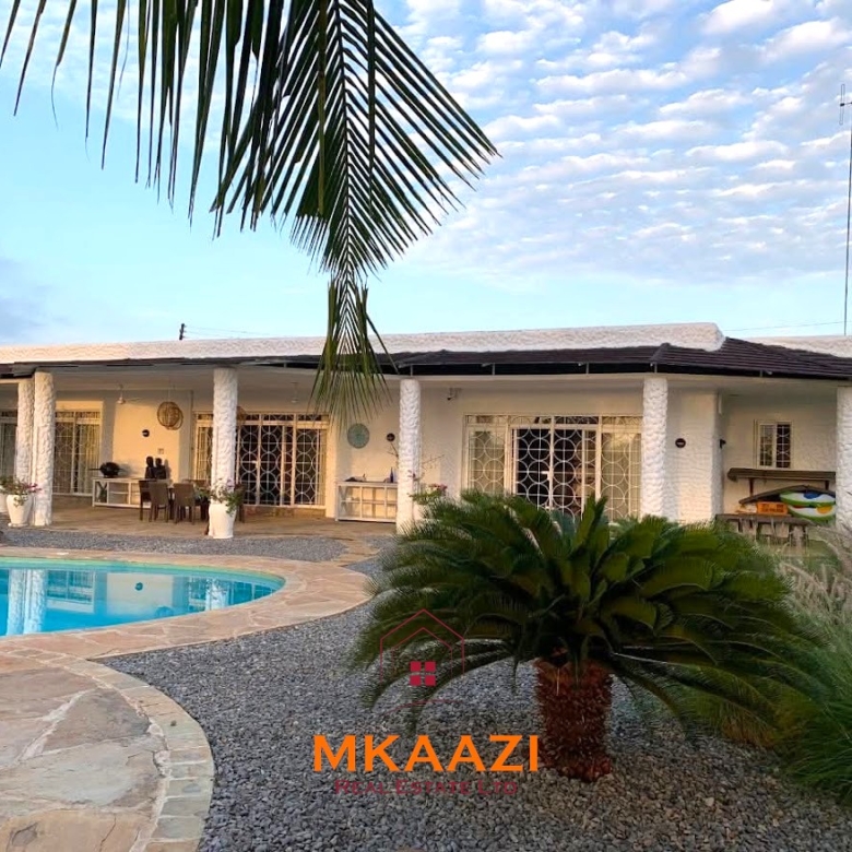 Luxury 3-bedroom all en-suite villa on 1.5 acres in Kikambala featuring a guest house, swimming pool, landscaped gardens, ocean breeze, and easy beach access.