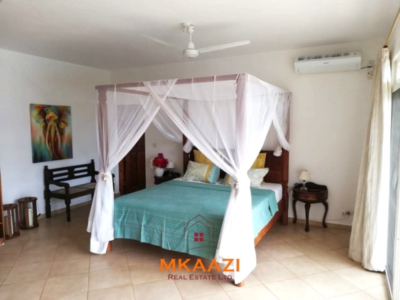 Luxury 3-bedroom all en-suite villa on 1.5 acres in Kikambala featuring a guest house, swimming pool, landscaped gardens, ocean breeze, and easy beach access.