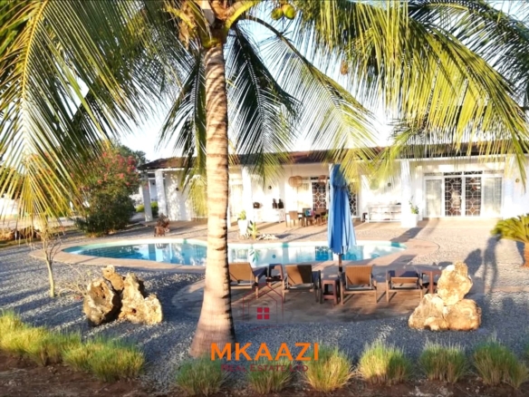 Luxury 3-bedroom all en-suite villa on 1.5 acres in Kikambala featuring a guest house, swimming pool, landscaped gardens, ocean breeze, and easy beach access.