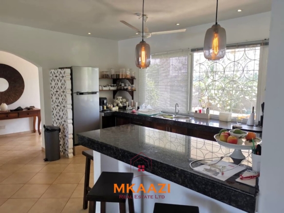 Luxury 3-bedroom all en-suite villa on 1.5 acres in Kikambala featuring a guest house, swimming pool, landscaped gardens, ocean breeze, and easy beach access.