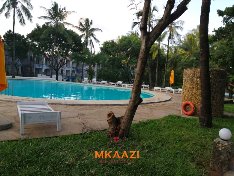 Fully furnished 85 sqm one-bedroom apartment for sale at Blue Marlin Sporting Resort Malindi with pool, gym, security, reception, and beach access.